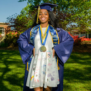 When Yahira Robinson graduates on May 6, she will wear a dress featuring the inspiring doodles and well-wishes of her North Guilford Middle School students.