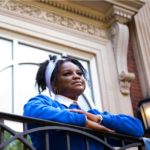 Antoinette Gregory, a UNCG McNair Scholar, peers into the distance outside of a building on campus