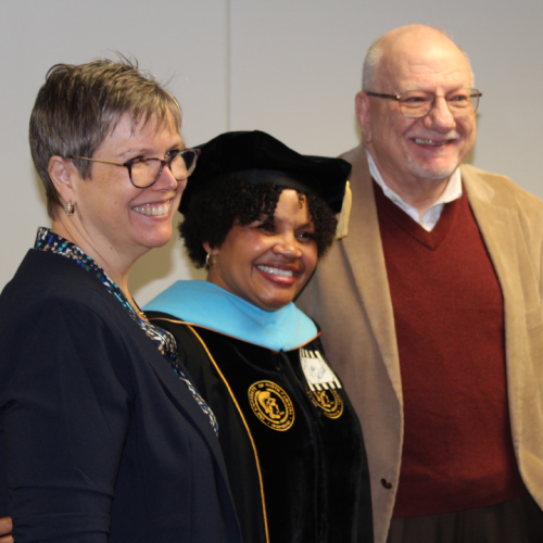 Drs. Christina O'Connor, Tina Chestnut, and Carl Lashley pose for a group photo at the ELC Doctoral Hooding Celebration ceremony in December of 2022