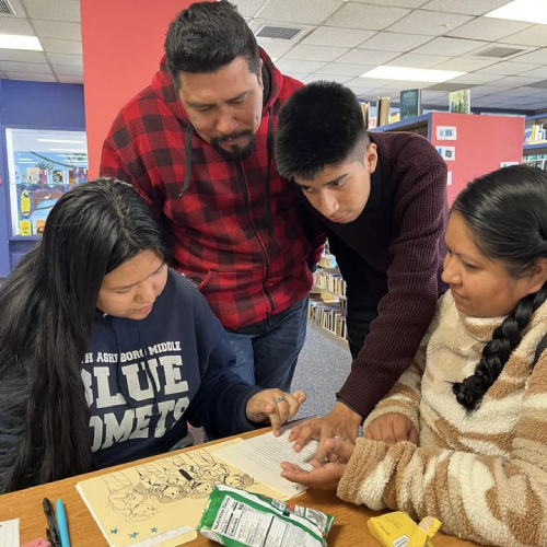 A family participating in the Heritage Language Academy looks at a story
