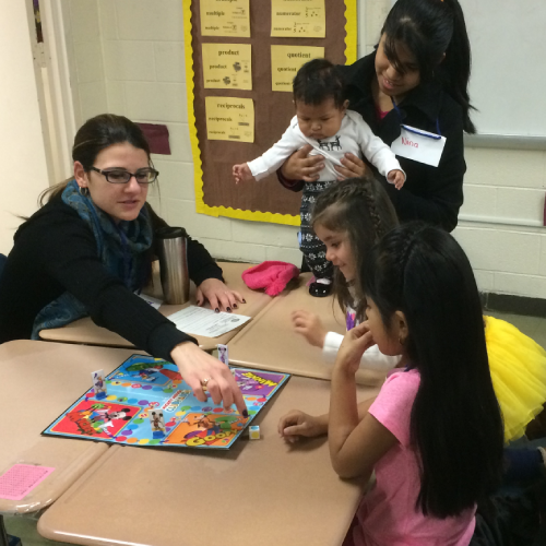 Children at the Real World English program play a game with an instructor