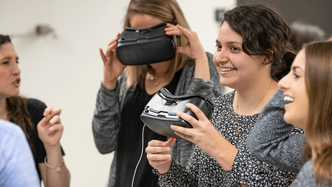 Students hold and use VR goggles