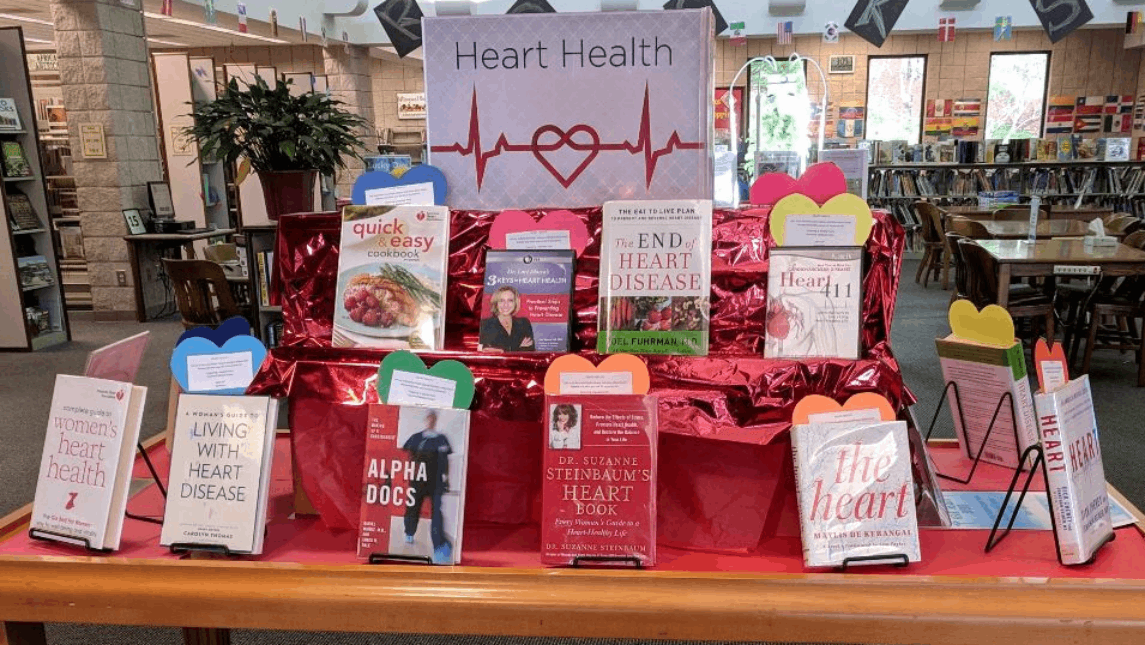 A collection of heart health books on a table