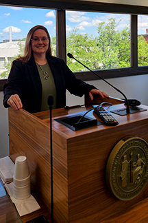 ILRS student Stacy Huff stands at a podium during Graduate Education Day