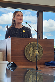 ILRS student Sarah Leck speaks at a podium during Graduate Education Day