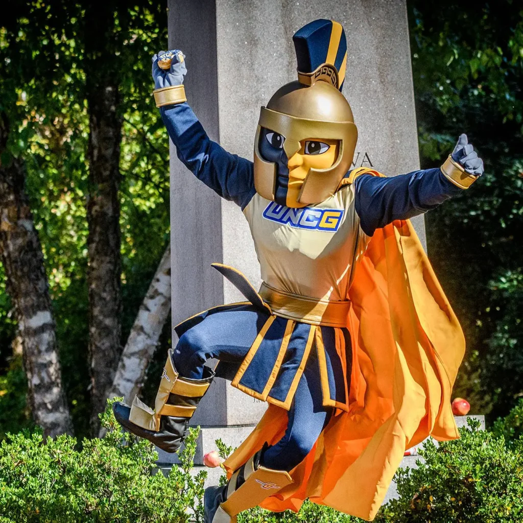 uncg spartan mascot leaping in the air