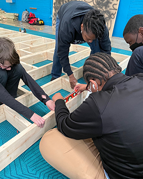 Youth at the Boys & Girls Club work to build a stage