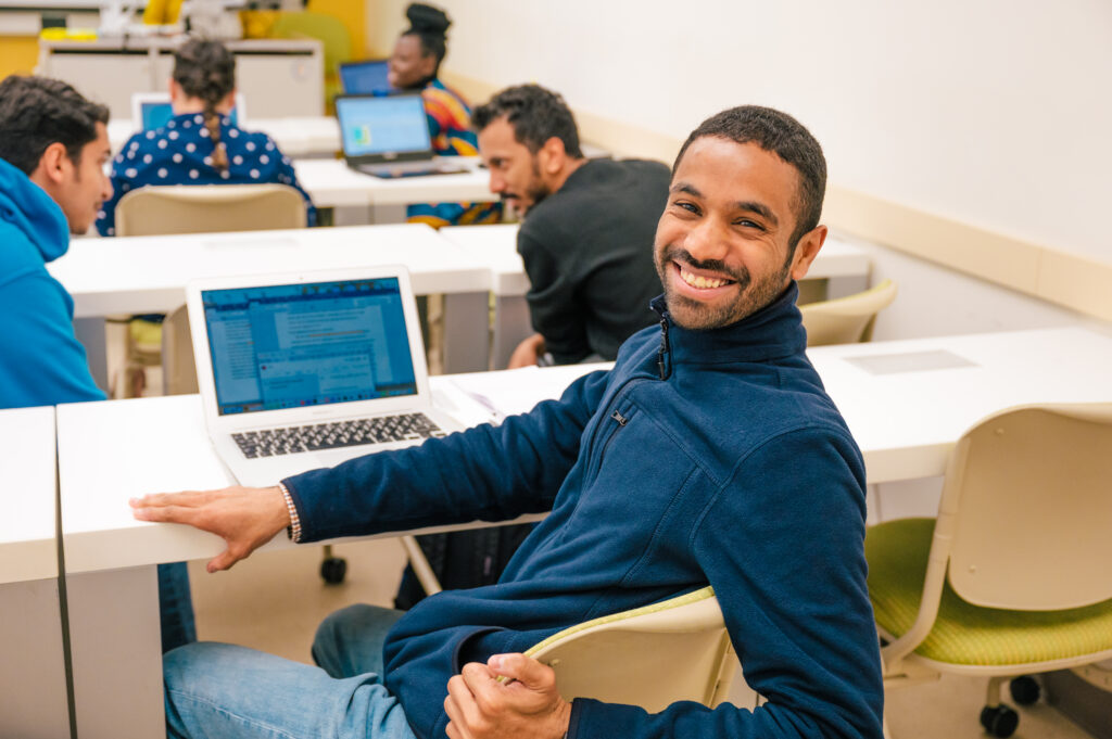 Students converse in a classroom setting