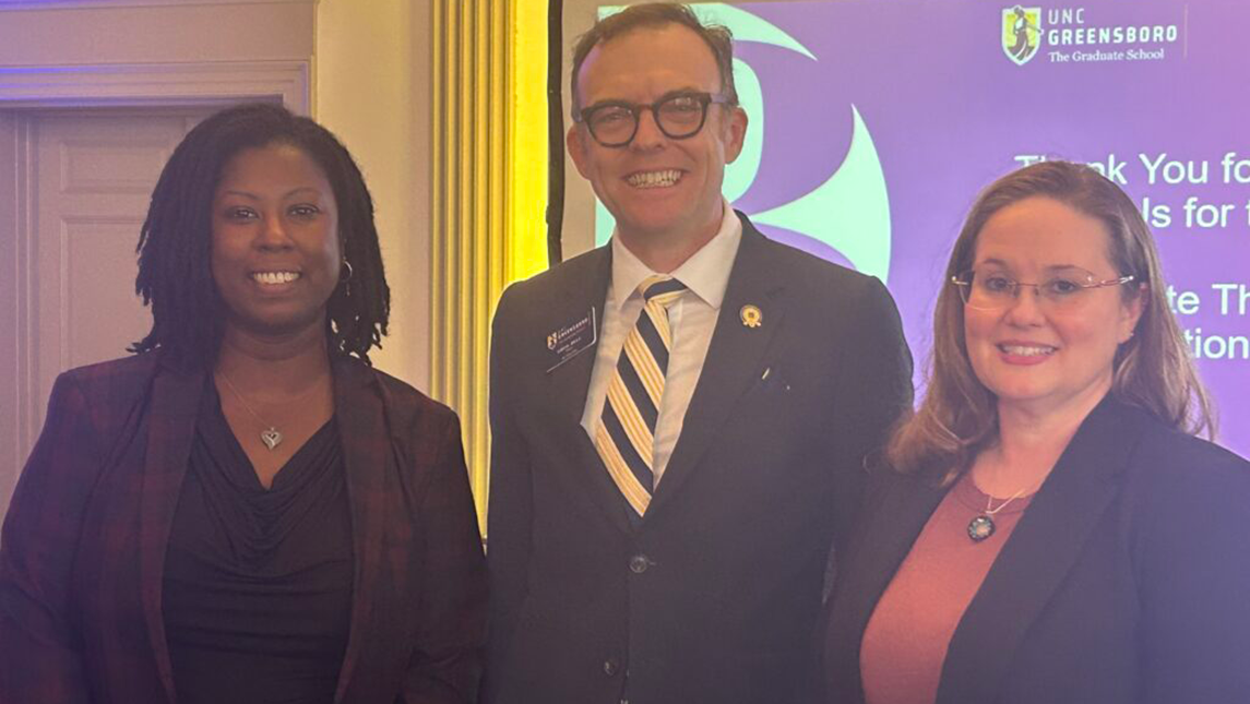 Stacy Huff, right, along with Dean of the Graduate School Greg Bell, center, and second-place finisher Ashley Herring-Nicholas following the 3MT competition