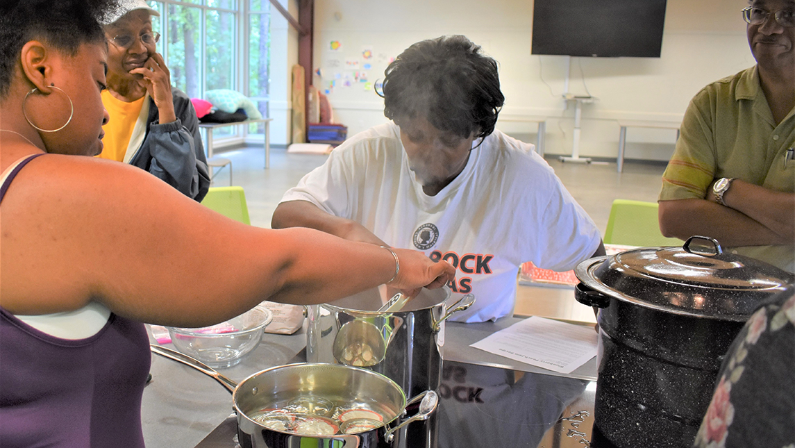 Community members learn to cook at the Dee Brown Library. Image courtesy Rosslynn Elliott, Creative Writer, Marketing & Resource Development staff member at the Library System.