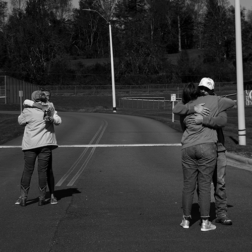 Two groups of people hug