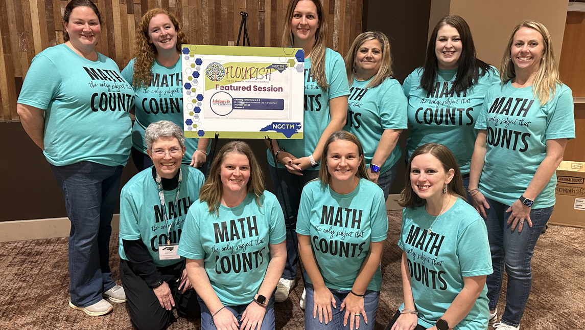 A group of ten people, including Dr. Vicki Jacobs (front row, left) wearing matching turquoise shirts that say “Math: the only subject that COUNTS” pose together indoors. They are smiling and standing around a sign that reads “Flourish Featured Session” with logos for the Ashboro City Schools and NCCTM.
