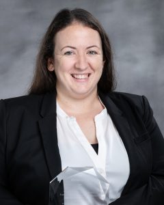 Meghan Leeming holds an award