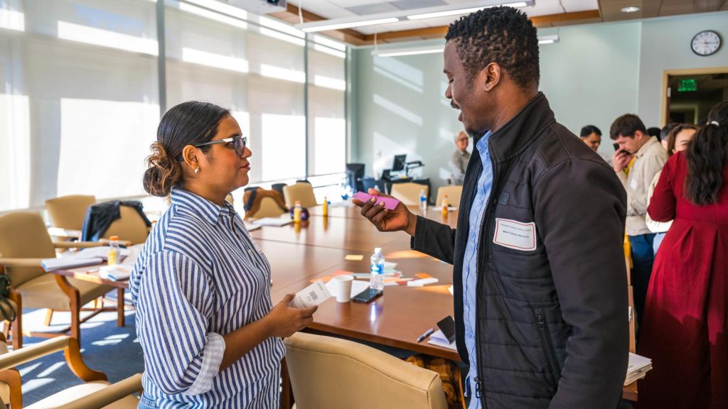 students engage with one another in an activity