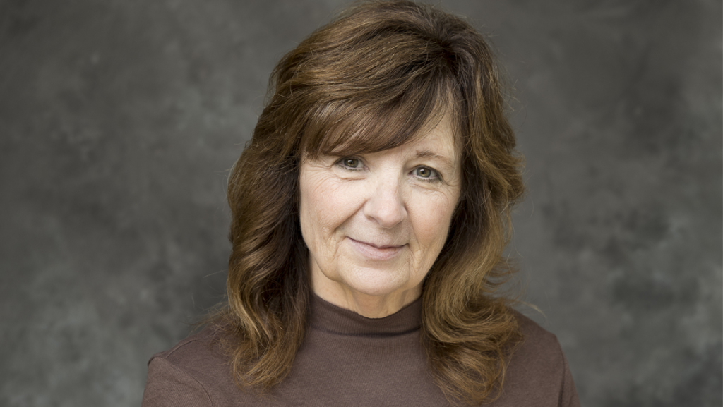 head shot of Dr. Marcia Rock in front of a gray background