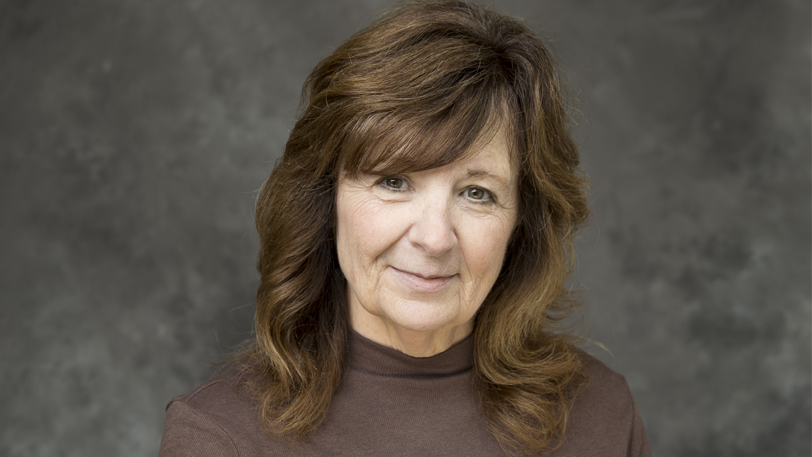 head shot of Dr. Marcia Rock in front of a gray background