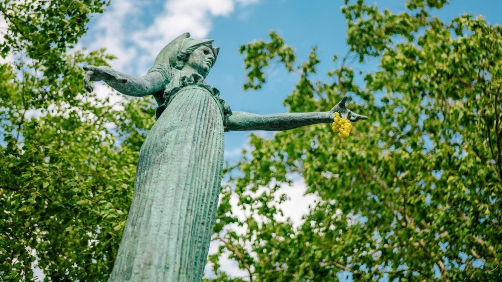 The Minerva Statue is holding grapes.