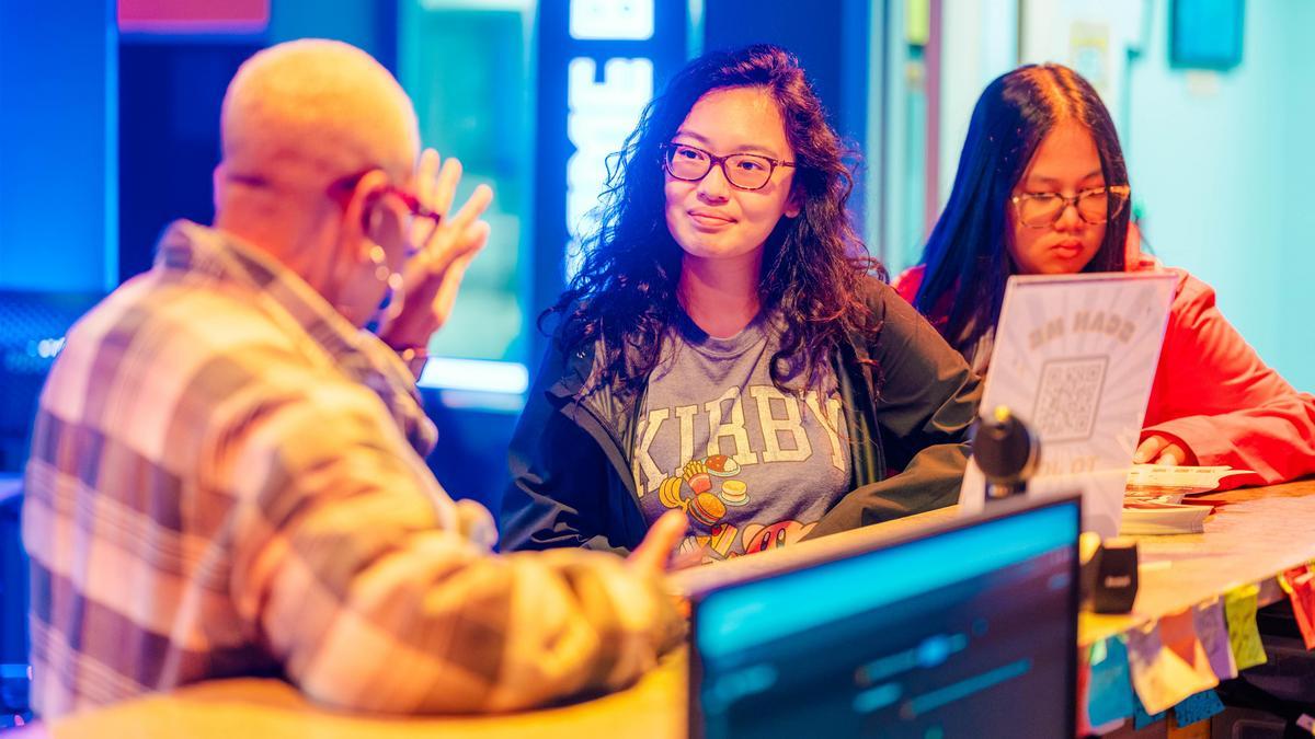 Information science students collaborating on data and technology projects in a hands-on university learning environment