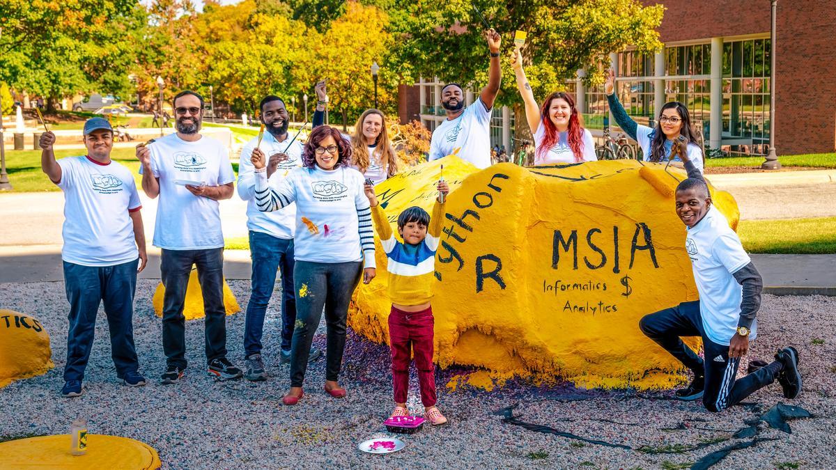 MSIA students painting the UNCG rock